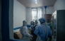 Dr Abdou Sebushishe (2nd L) Senior Health Advisor at International Medical Corps, guides and shows CBCA Virunga doctors how to properly put on single-use personal protective equipment provided by International Medical Corps, as part of support for Ebola virus disease prevention measures in Goma, on May 21, 2026. (Photo by Jospin Mwisha / AFP)