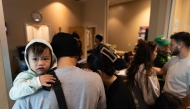 Evacuees check-in at a shelter after a chemical leak from a large storage tank threatened residents in Garden Grove, California on May 22, 2026. (Photo by Blake Fagan / AFP)