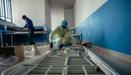 Technicians install beds and other equipment inside the isolation area for suspected cases at CBCA Virunga Hospital during rehabilitation work aimed at preparing the facility to receive potential Ebola cases, on May 22, 2026. (Photo by Jospin Mwisha / AFP)
