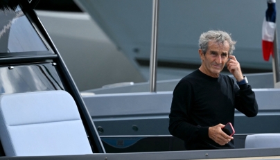 :(FILES) French former driver Alain Prost arrives by boat in the paddock of the Circuit de Monaco before the third practice session of the Formula One Monaco Grand Prix on May 25 2024, on the eve of the race. (Photo by NICOLAS TUCAT / AFP)