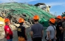 This handout photo taken and released on May 24, 2026 via the Facebook page of the Angeles City Public Information Office shows rescuers standing next to a collapsed building in Angeles City in Pampanga province. (Photo by Handout / Angeles City Public Information Office / AFP) 