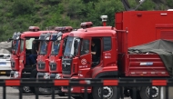 Drivers wait in rescue vehicles outside the Liushenyu coal mine, where an explosion killed dozens in Qinyuan county, in China痴 northern Shanxi province on May 24, 2026. 
(Photo by GREG BAKER / AFP)