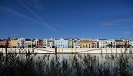 A picture taken on April 30, 2026 shows residential buildings alongside the Guadalquivir river on Betis street in Seville. Photo by CRISTINA QUICLER / AFP