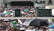 Muslim worshippers walk along the Grand Mosque complex under the water-mist fans installed in the holy city of Mecca on May 24, 2026, ahead of the annual Hajj pilgrimage. (Photo by Zain Jaafar / AFP)