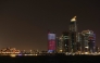 Illuminated skyscrapers are pictured along the corniche promenade in Doha on May 15, 2026. Photo by Karim JAAFAR / AFP