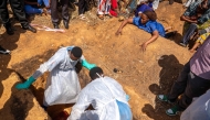 A woman (top R) reacts as a person suspected of having died from Ebola is buried in Bunia, in the eastern Democratic Republic of the Congo, on May 25, 2026. (Photo by Glody MURHABAZI / AFP)
