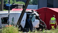 This photograph shows a damaged train car at the site of an accident after a train crashed into a school bus, at the railway crossing Vierhuizen in Buggenhout on May 26, 2026. (Photo by Dirk Waem/ BELGA / AFP)