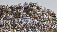 Muslim pilgrims pray on  Mount Arafat, also known as Jabal al-Rahma or Mount of Mercy, in Makkah, Saudi Arabia, on May 26, 2026. (Photo by Zain JAAFAR / AFP)