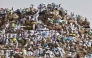 Muslim pilgrims pray on  Mount Arafat, also known as Jabal al-Rahma or Mount of Mercy, in Makkah, Saudi Arabia, on May 26, 2026. (Photo by Zain JAAFAR / AFP)