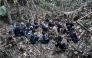 This handout image released by Metta Tham Rescue Kalasin on May 26, 2026, shows rescue workers gathering near a cave in Xaisomboun province. (Photo by Handout / Metta Tham Rescue Kalasin / AFP) 