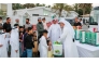 Ministry of Awqaf and Islamic Affairs representatives distributing gifts to children as part of the ‘Joy of Eid’ initiative.