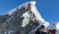 This photograph taken on May 20, 2026, shows mountaineers climbing a slope lined up during their ascent from the Hillary Step to summit Mount Everest in Nepal. Photo by Furte Sherpa / AFP