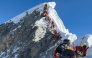 This photograph taken on May 20, 2026, shows mountaineers climbing a slope lined up during their ascent from the Hillary Step to summit Mount Everest in Nepal. Photo by Furte Sherpa / AFP