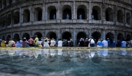 People sit in the shade of the Colosseum during an early-season heatwave in Rome on May 28, 2026. Photo by TIZIANA FABI / AFP