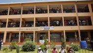 Relatives gather and wait for news of their loved ones at the Utumishi Girls Academy following the deadly fire in Gilgil, north of the capital Nairobi on May 28, 2026. (Photo by Simon Maina / AFP)
