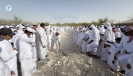 People take part in the burial of Abdullah bin Hamad Al Attiyah.