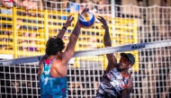 Qatar's Ahmed Tijan (right) shoots to score a point.