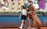 Japan's Naomi Osaka walks on court with a mascot for her women's singles match at the Roland-Garros Complex in Paris on May 30, 2026. (Photo by Thomas Samson / AFP)
