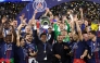 Paris Saint Germain's president Nasser al-Khelaifi (C) lifts the trophy as he celebrates with his players winning the UEFA Champions League final football match between Paris Saint-Germain (PSG) and Arsenal FC at the Puskas Arena in Budapest on May 30, 2026. (Photo by FRANCK FIFE / AFP)