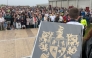 The O’Sullivan clan family crest is held by a participant in a bid to break a world record for the largest gathering of people with the same surname, in Castletownbere, Ireland (Photo by Peter Murphy/ AFP)