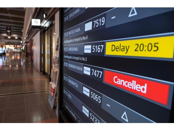 A departures board shows a cancelled flight to Okinawa after Severe Tropical Storm Jangmi shut down the airport at Haneda Airport in Tokyo on June 1, 2026. (Photo by Andrew Caballero-Reynolds / AFP)