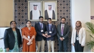 The winning team with the school officials.