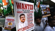 Indian Youth Congress party workers hold placards of India's Education Minister Dharmendra Pradhan during a protest against National Testing Agency (NTA) in Mumbai on June 2, 2026. (Photo by Indranil Mukherjee / AFP)