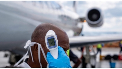 A passenger's temperature is checked at Bunia Airport in eastern Democratic Republic of the Congo on June 3, 2026. Photo by GLODY MURHABAZI / AFP