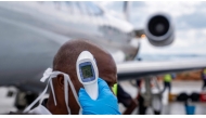 A passenger's temperature is checked at Bunia Airport in eastern Democratic Republic of the Congo on June 3, 2026. Photo by GLODY MURHABAZI / AFP