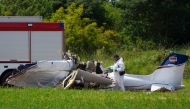 A police officer in protective gear collects evidences at site of a small plane crash, which killed 4 people, in Medulin on Croatia's northern Adriatic coast, on June 4, 2026. Photo by AFP