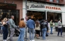 People wait in line outside L'industrie Pizzeria in New York City on May 15, 2026. (Photo by Angela Weiss / AFP)