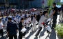 Students enter a school on the first day of China's National College Entrance Examination (NCEE) known as 