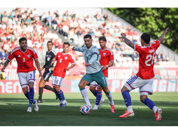 Portugal's Cristiano Ronaldo (centre) controls the ball.