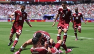 Boualem Khoukhi celebrates with teammates after scoring Qatar's first goal against Switzerland during the FIFA World Cup 2026 Group B match at San Francisco Bay Area Stadium on June 13, 2026 in Santa Clara, California.