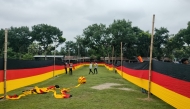 People look at a 7.5 kilometres (4.7 miles) long national flag of Germany commisioned by their football team fan Bangladeshi farmer Amjad Hossain, upon its display across a field in Magura district on June 10, 2026, on the eve of the 2026 FIFA World Cup tournament. Photo by AFP