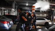 NYPD officers arrest a man after the New York knicks defeated the San Antonio Spurs in Game 5 of the NBA Finals to win the series, in New York, on June 14, 2026.
(Photo by kena betancur / AFP)