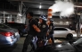 NYPD officers arrest a man after the New York knicks defeated the San Antonio Spurs in Game 5 of the NBA Finals to win the series, in New York, on June 14, 2026.
(Photo by kena betancur / AFP)