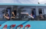 Migrants wave to people their goodbyes as the first of seven buses leave the Sherwood Park in Durban on June 14, 2026. (Photo by RAJESH JANTILAL / AFP)
 
