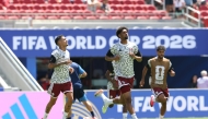 Qatar's Edmilson Junior (left), Homam Al Amin (centre) and Jassim Jaber warm up ahead of match against Switzerland.