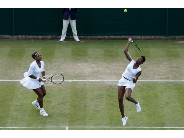 A file photo of the sisters Serena Williams (L) and Venus Williams playing against Belgium's Elise Mertens and Belgium's An-Sophie Mestach during their women's doubles second round match on the sixth day of the 2016 Wimbledon Championships at The All England Lawn Tennis Club in Wimbledon, southwest London, on July 2, 2016. Photo by ADRIAN DENNIS / AFP