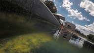 Seen through algae-laden green water, a tear in the recently applied sealant can be seen on the bottom of the Lincoln Memorial Reflecting Pool on June 18, 2026 in Washington, DC. (Photo by Oliver Contreras / AFP)
