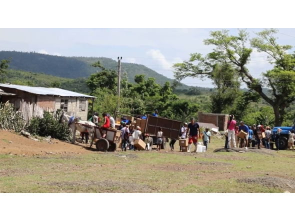 This AFPTV screengrab shows residents affected by Hurricane Melissa on October 29, 2025 receiving humanitarian aid from Caritas volunteers, on June 13, 2026. (Photo by AFPTV STRINGER / AFP)
