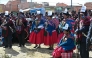 Indigenous people wearing signs reading 