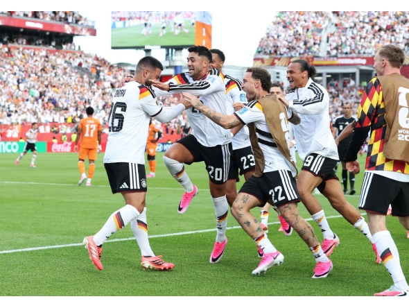Deniz Undav (left) celebrates with teammates after scoring Germany's second goal.