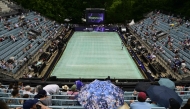 The court is covered and spectators use umbrellas as rain started after the first women's singles semi-final match at the WTA500 Berlin Tennis Open tournament in Berlin on June 20, 2026. (Photo by John MacDougall / AFP)