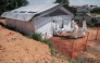 Members of specialized response teams enter the morgue of the Evangelical Medical Center of Nyankunde (CME) with the body of a person who died from Ebola virus disease to allow relatives to pay their last respects after washing, disinfection and safe body-wrapping procedures in Bunia, Ituri Province, Democratic Republic of Congo, on June 13, 2026. (Photo by Jospin Mwisha / AFP)