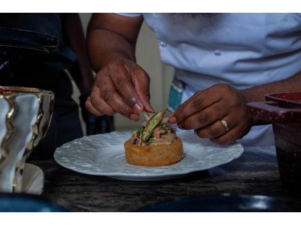 Congolese chef Archi Dimosi plates one of his signature dishes in Kinshasa on May 17, 2026. (Photo by Hardy Bope / AFP)
