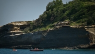 Firefighters search by boat at the base of the cliff from which a section collapsed near Miramar beach, killing one woman and leaving a diver missing, in Biarritz, south-western France, on June 25, 2026. Photo by PHILIPPE LOPEZ / AFP