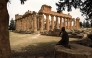 (Files) A man sits in the shade in front of the Temple of Zeus at the archaeological site of Cyrene, near the town of Shahat on Libya's northeastern Mediterranean coast, on May 18, 2026. (Photo by Abdullah Doma / AFP)