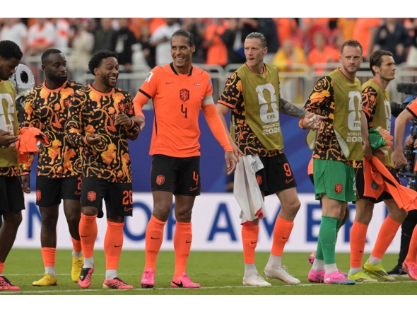 From L: Netherlands' midfielder #26 Quinten Timber, defender #04 Virgil van Dijk and forward #09 Wout Weghorst celebrate after winning the 2026 World Cup Group F football match between Tunisia and the Netherlands. (Photo by Juan Mabromata / AFP)